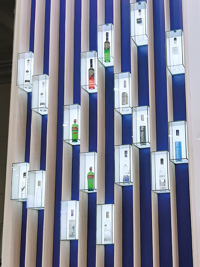 glass boxes with bottles of alcoholic drinks on the stand